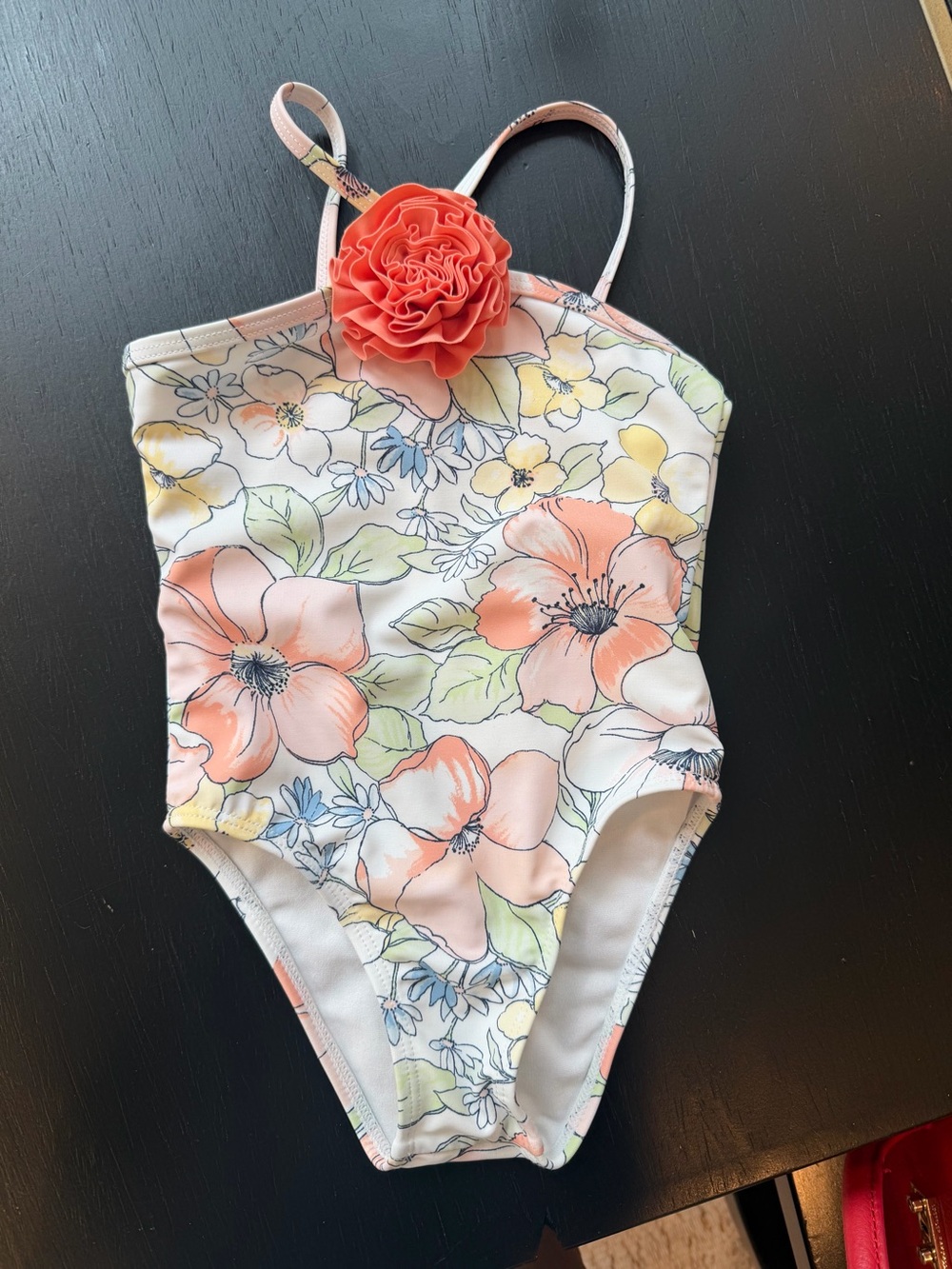 Janie and Jack floral one-piece swimsuit features a coral rosette